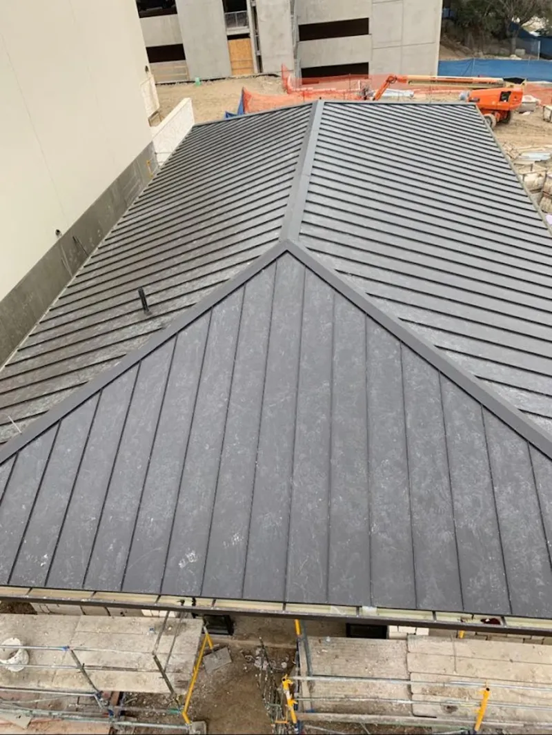 Commercial metal roof construction with crane equipment in Garfield Heights