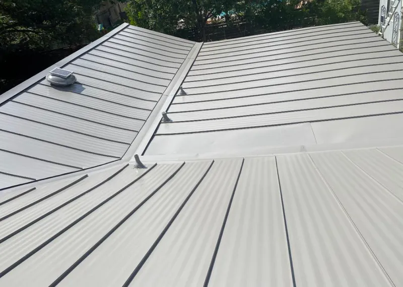 Solar attic fan installed on a metal roof for Roof Ventilation in Garfield Heights